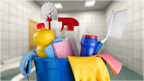 Cleaner using protective equipment while operating carpet cleaning machinery