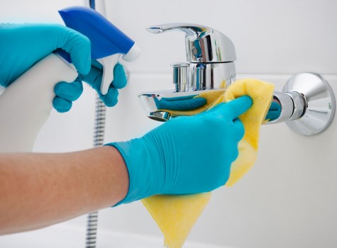 Professional hot water extraction cleaning a carpet in a Grahame Park home